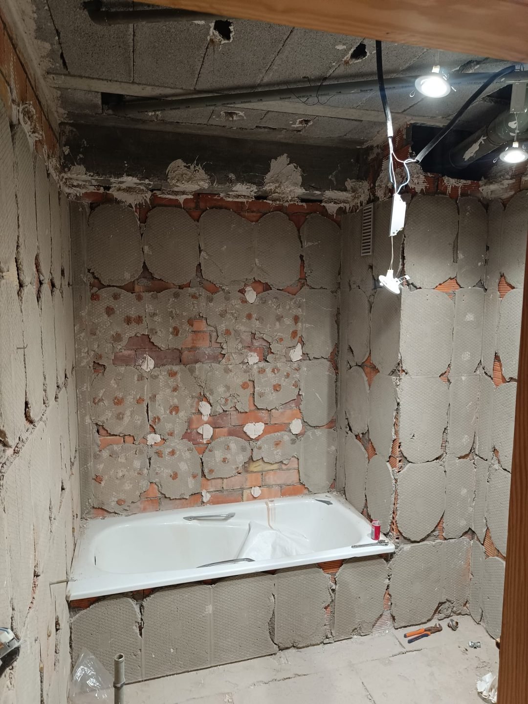 Walls stripped and ceiling opened up, with the services exposed